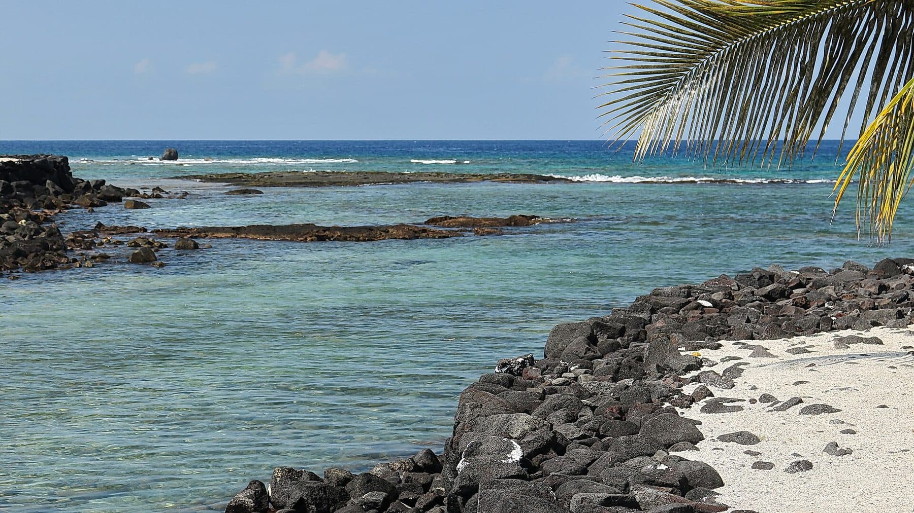 Clear water lapping the lava ledges at Hōnaunau Bay, home of the Two Step snorkel entry